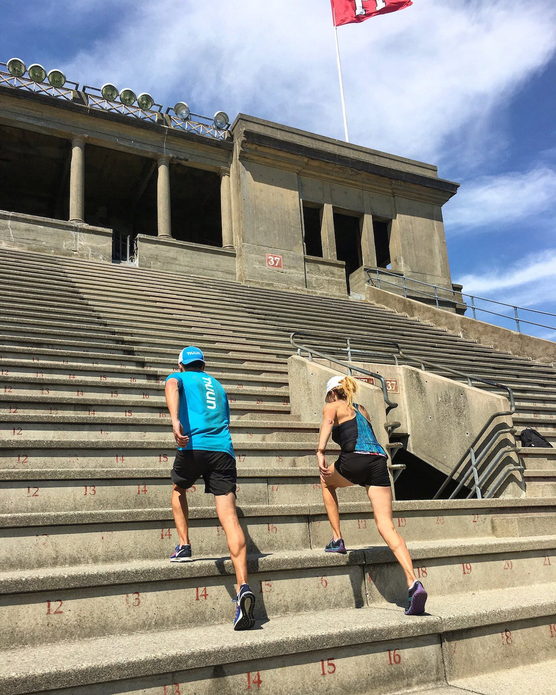 Two people doing a workout running up stairs