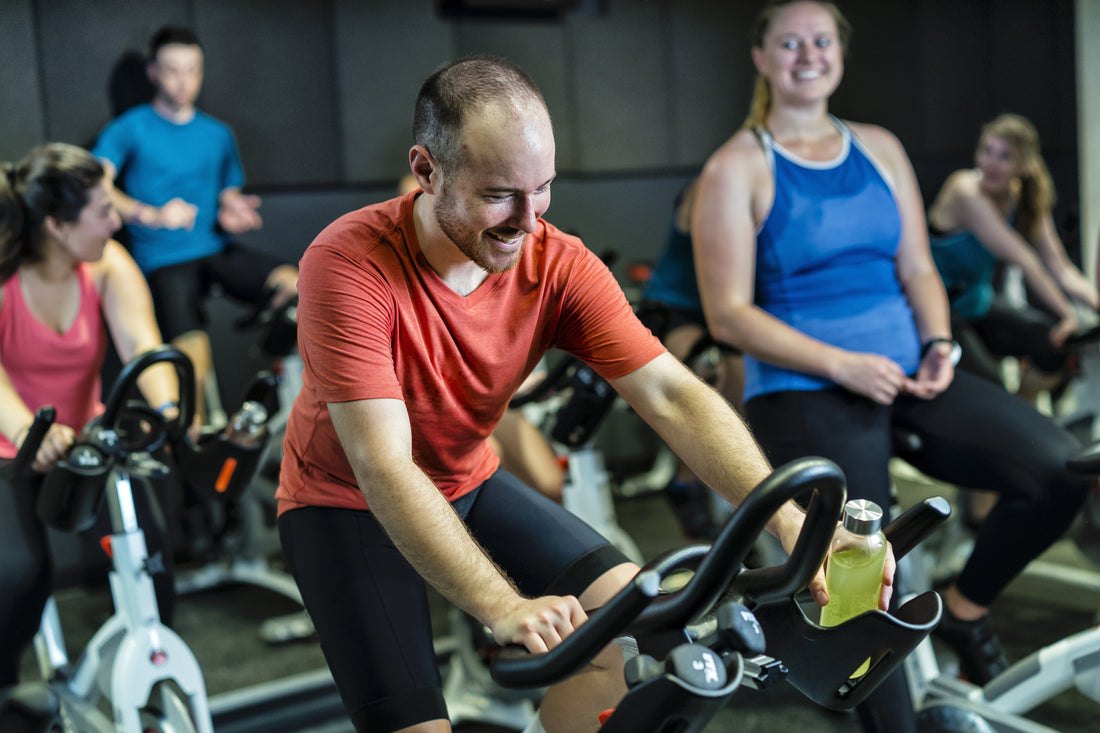 Group of spin class attendees working out before work