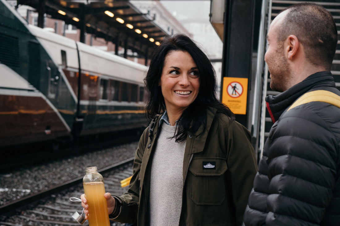 Two people drinking Nuun Immunity at a train station