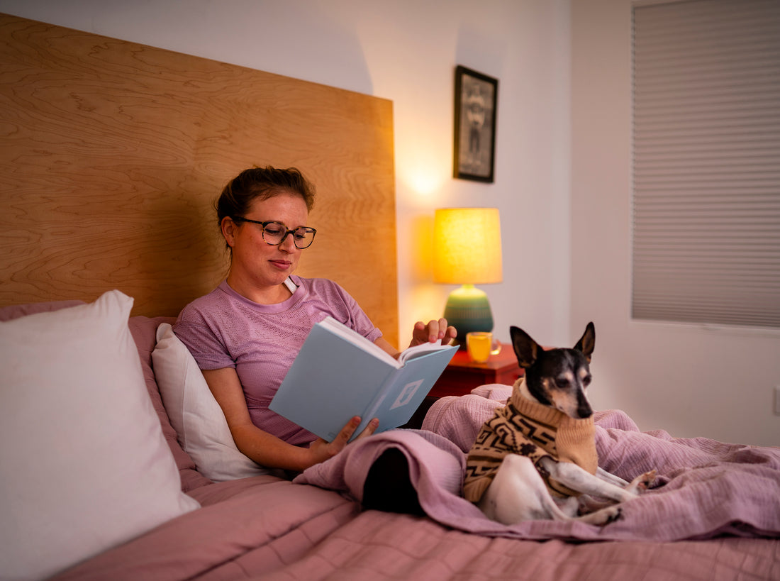 Person reading in bed to help with sleep hygiene