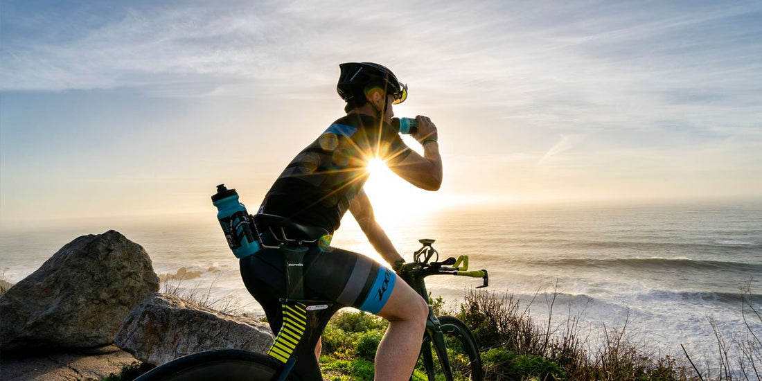 cyclist drinking nuun endurance during the sunset