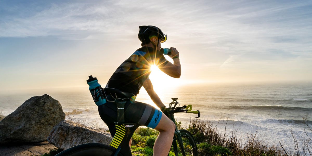 cyclist drinking nuun endurance during the sunset
